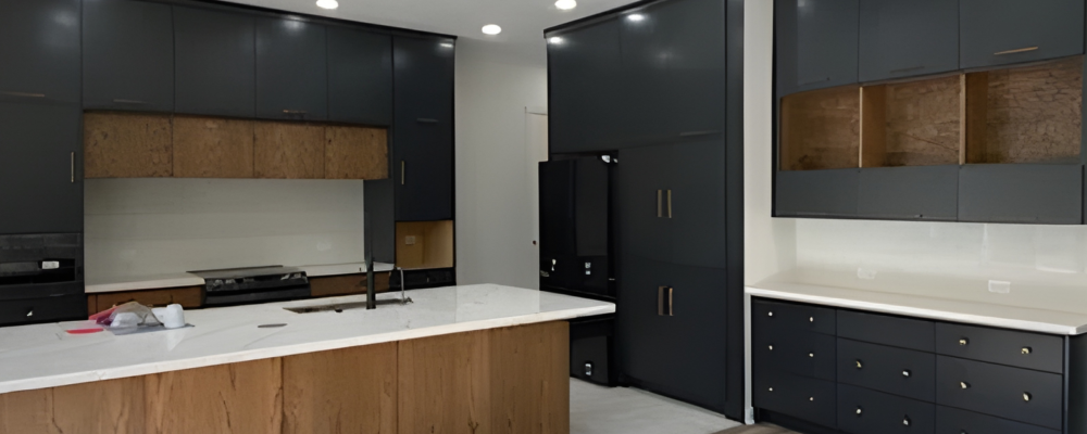 Contemporary kitchen remodel in Houston with matte black cabinets and a large wood island.