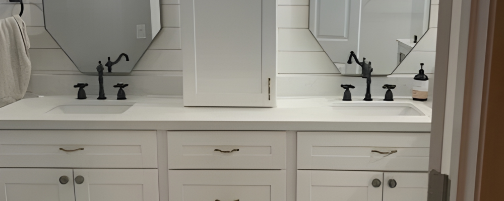 Modern white bathroom remodel in Houston with shiplap walls and double vanity with octagonal mirrors.